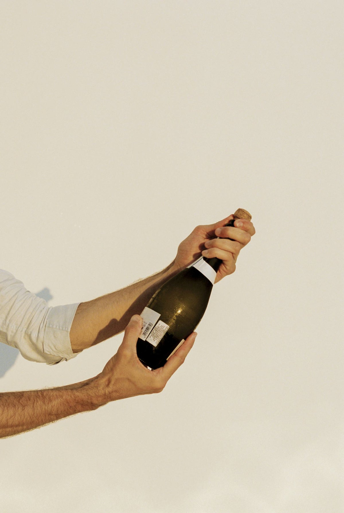 Someone receiving wine bottle as a gift