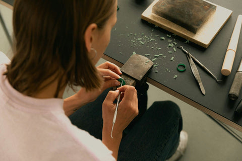 Person working on a craft project with tools on a table