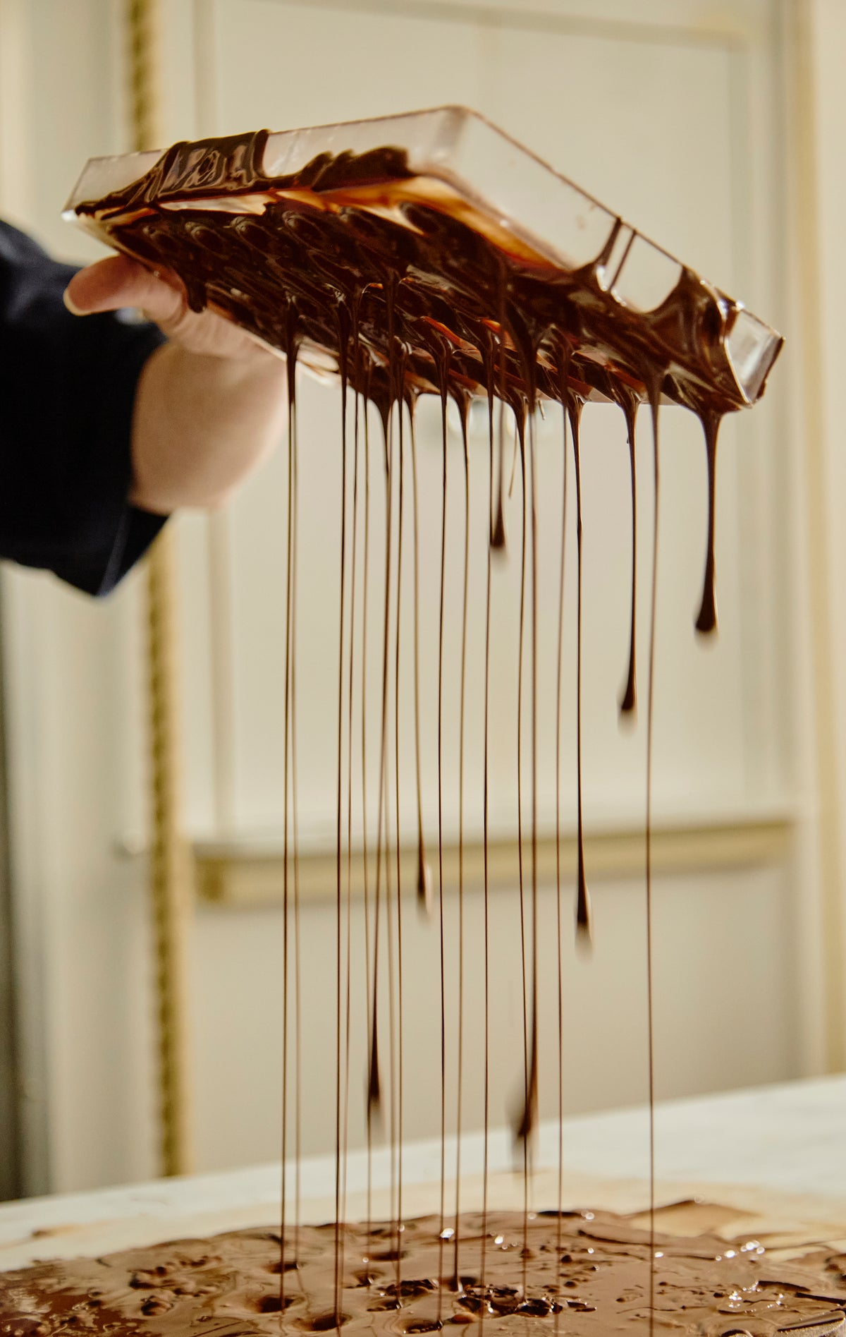 Chocolate draining from a mould at Audrey’s, approximately June 2025. Photograph: Becca Jones.