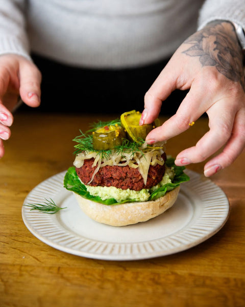 A burger finished with Wild Root Bread and Butter Pickles