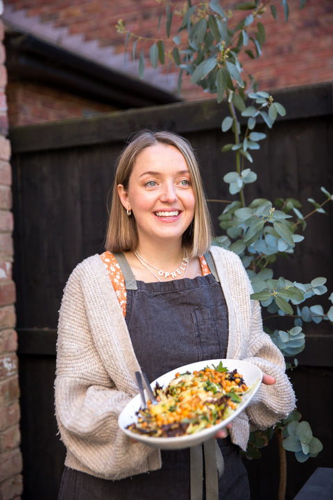 Charlie, founder of Wild Root, holding a dish